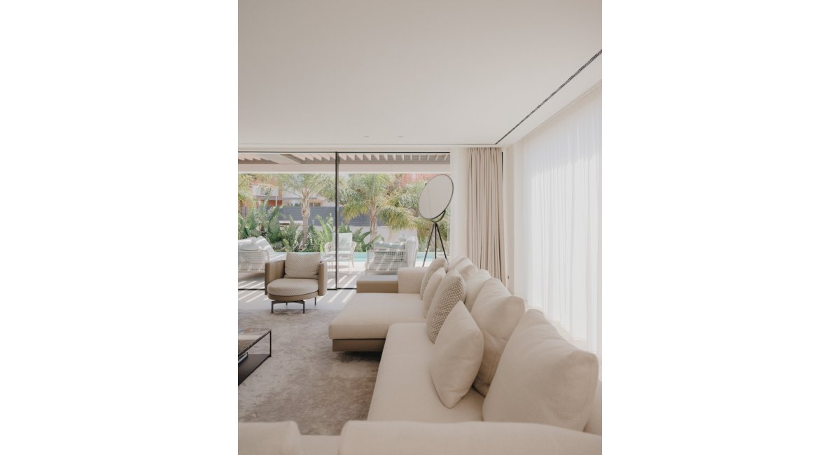 Sofá y mesa de centro MINOTTI en el salón con la lampara de pie de FLOS, MINIM Barcelona