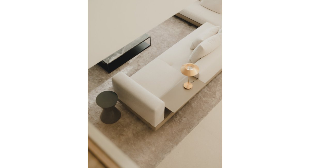 Sofá y mes auxiliar de MINOTTI con lámpara de mesa de VIBIA en el salón, MINIM Barcelona